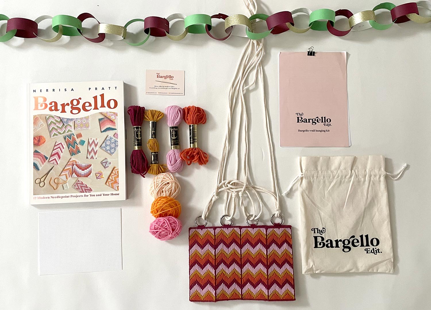 flat lay of a Bargello Edit wall hanging kit and a book 