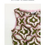 A close up image of one of our garments with no sleeves. The garment is green and white swirled pattern with a sparkly pink texture.